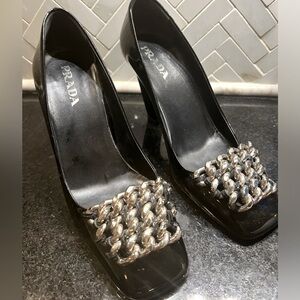 Prada black patent leather pumps with silver chain-link detailing